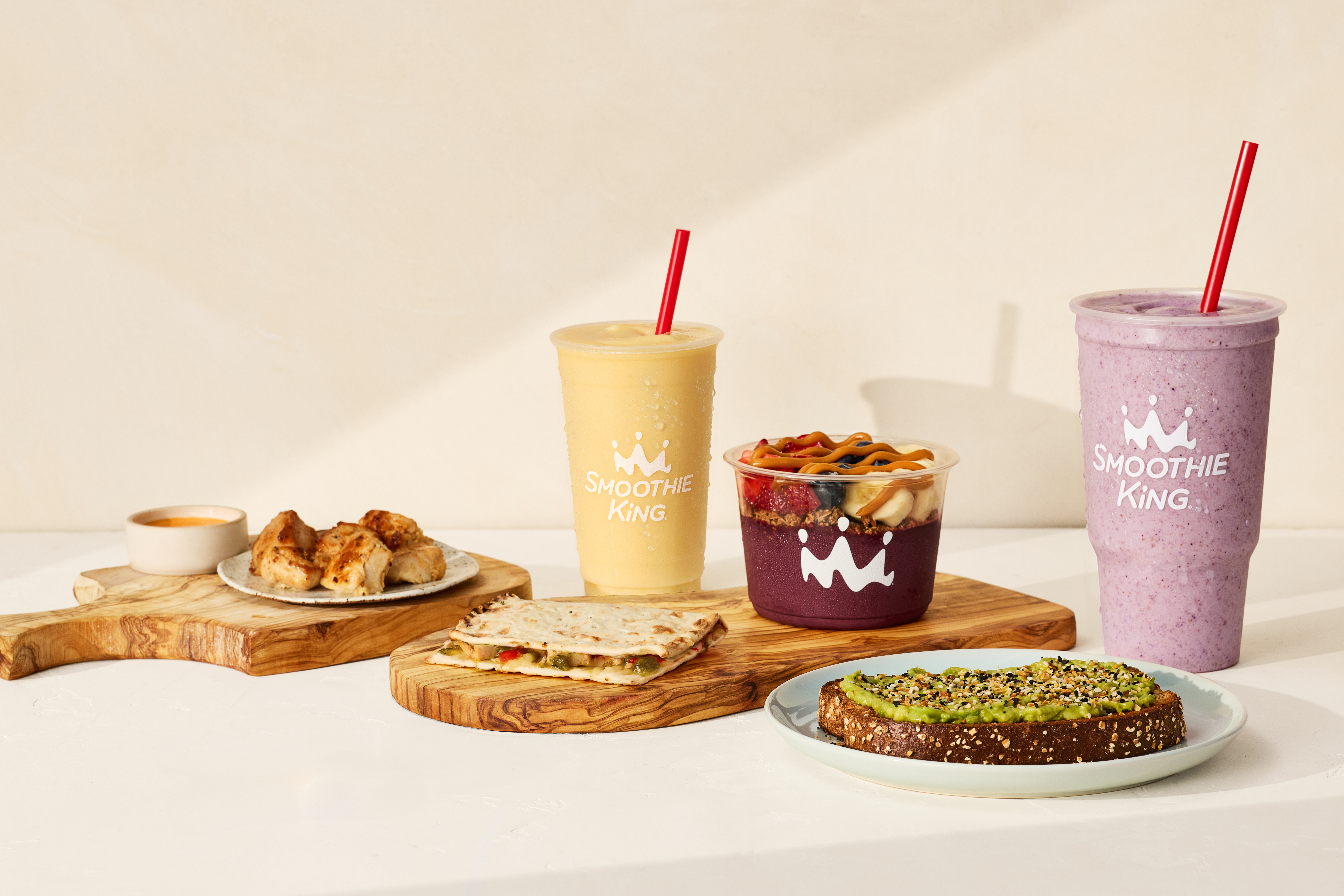 Smoothie King food and smoothie pairings on a table.