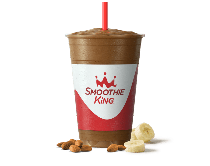A dark chocolate banana smoothie from Smoothie King with fresh ingredients beside it